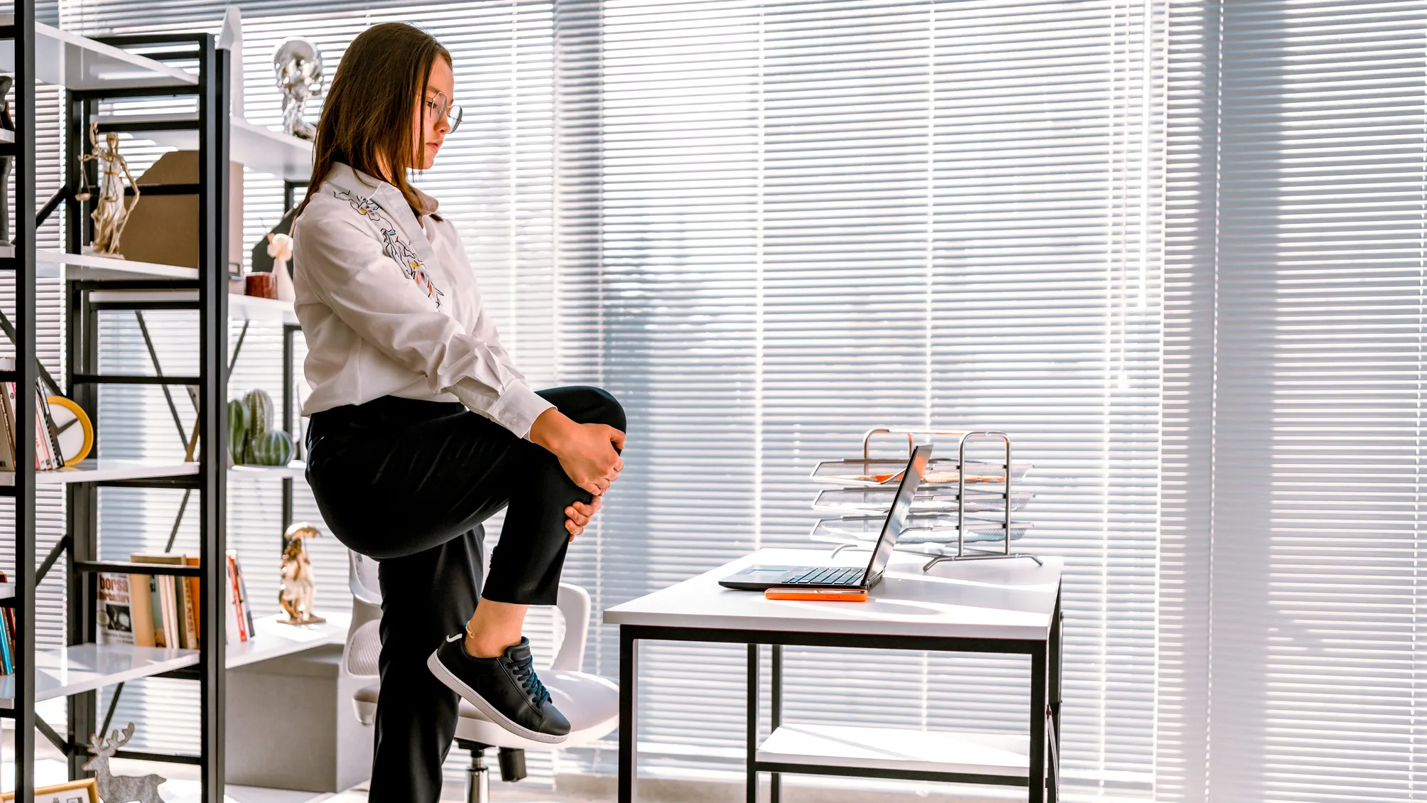 Person stretching at their desk during a work break